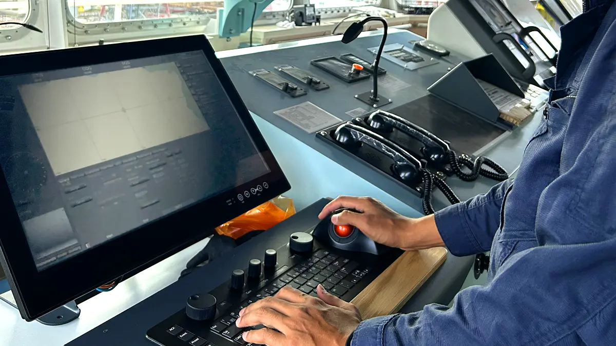 Marine Enterprise engineer inspects electronic chart display on a commercial ship in Kobe Port